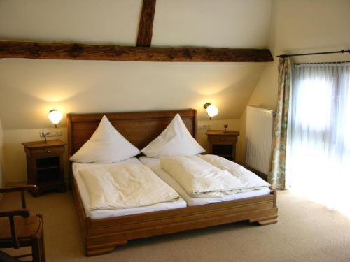 a bedroom with a bed with two pillows on it at Egestorfer Hof in Egestorf
