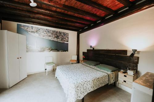 a bedroom with a bed and a wooden ceiling at antonella home in Brindisi