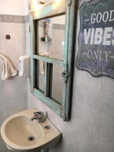 a bathroom with a sink and a mirror at Destino26 Hostel in Montevideo