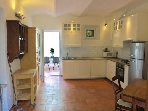 a kitchen with white cabinets and a table and a dining room at DaLu Florence apartment Davide - private car park 15 minutes to the city center in Florence