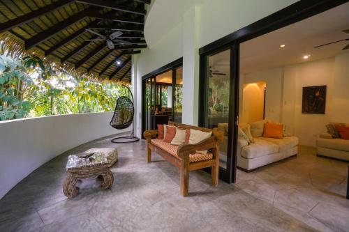 a living room with a couch and a table at Makara Mono Suite / 2nd Floor in Uvita