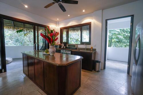 a kitchen with a large island with a counter top at Makara Mono Suite / 2nd Floor in Uvita