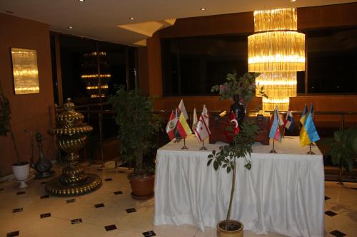 a table with different flags on it in a room at Akyuz Hotel in Ankara