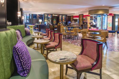 a restaurant with chairs and tables and a bar at Staypineapple, The Maxwell Hotel, Seattle Center Seattle in Seattle