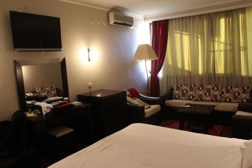 a hotel room with a bed and a couch at Akyuz Hotel in Ankara
