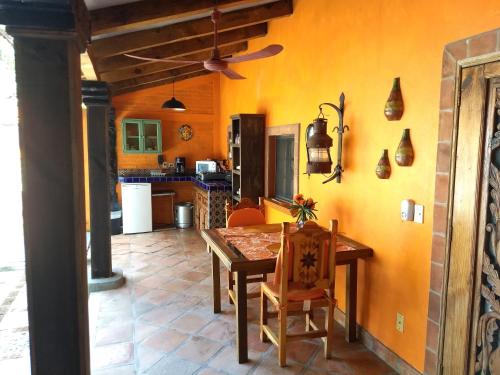 a kitchen with a wooden table and a dining room at Casa de Como in Ajijic