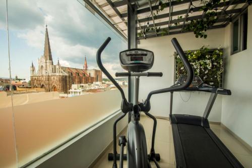a bike in a room with a view of a church at Concept Hotel in Zamora de Hidalgo