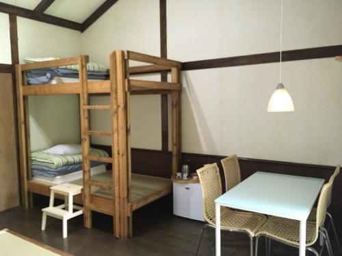 a dining room with bunk beds and a table at A private retreat Cotton Club Cottage in Takamori