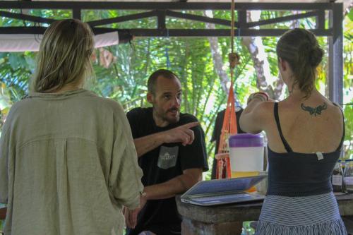 a group of people standing around a man talking at La Bambouseraie in Balgue