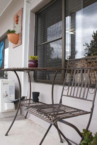 a bench sitting on a porch next to a window at Karuah Riverside Motel in Karuah