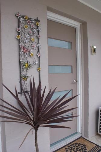 a plant is in front of a door at Karuah Riverside Motel in Karuah