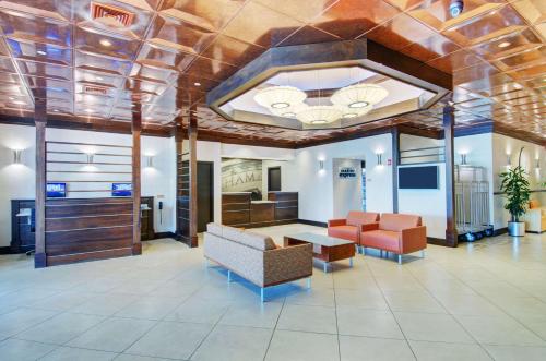 a lobby with a couch and a table and chairs at Best Western Plus Waltham Boston in Waltham