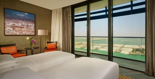 a bedroom with two beds and a view of the ocean at Grand Hyatt Abu Dhabi Hotel & Residences Emirates Pearl in Abu Dhabi