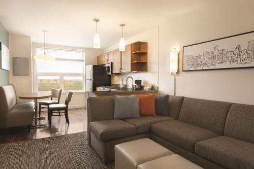 a living room with a couch and a table at Hyatt House Denver Airport in Denver