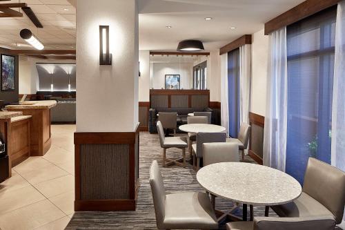 a dining room with chairs, tables, and a large window at Hyatt Place Atlanta/Cobb Galleria in Atlanta