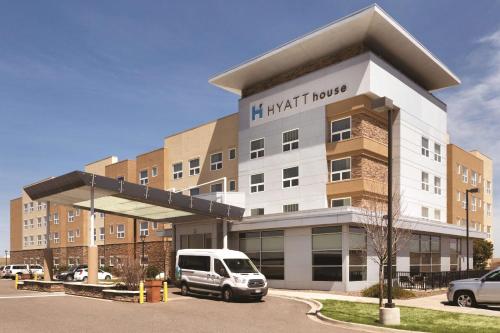 a building with a van parked in front of it at Hyatt House Denver Airport in Denver