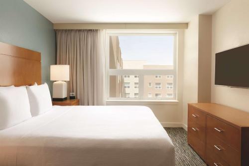 a hotel room with a bed and a window at Hyatt House Denver Airport in Denver