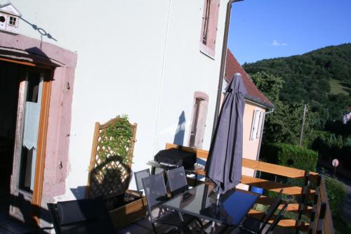 a patio with an umbrella and chairs on a balcony at Apartment Au Calme in Munster