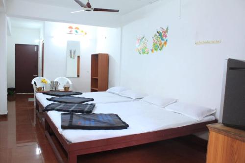 a bedroom with two beds with towels on them at Breezy Land Residency (Nidhi Sri & k.k resort) in Yercaud
