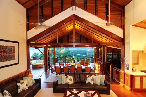 a living room with a couch and a table at Villa Empat Puluh Dua in Port Douglas