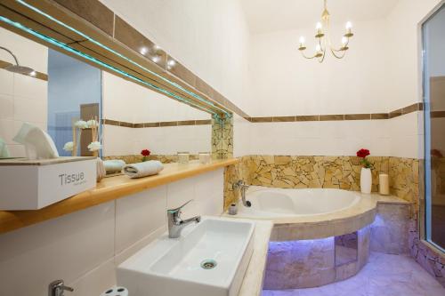 a large bathroom with a tub and a sink at Penzión ARTin in Nitra