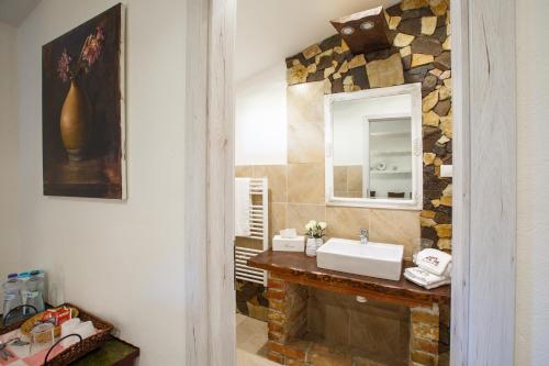 a bathroom with a sink and a mirror at Penzión ARTin in Nitra