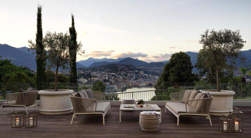 a row of chairs sitting on top of a patio at The View Lugano in Lugano