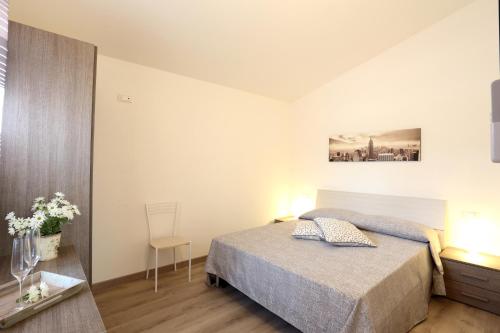 a bedroom with a bed and a table and a chair at Villaggio Olmè in Cessalto
