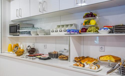 a shelf filled with different types of food at Suite Home Sardinero in Santander