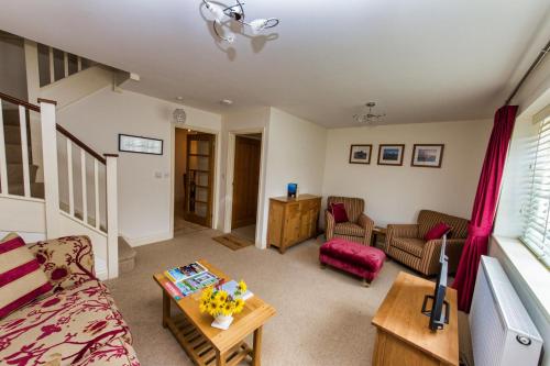 a living room with a couch and a table at Broads Reach in Stalham