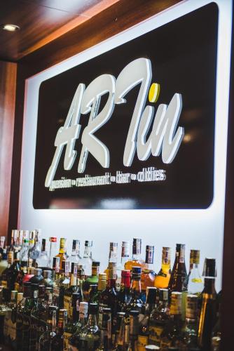 a sign above a bar with bottles of alcohol at Penzión ARTin in Nitra