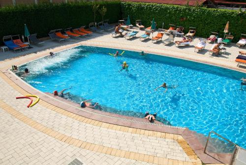 a group of people swimming in a swimming pool at Hotel Columbia Terme in Abano Terme