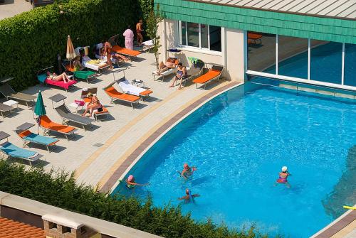 a group of people swimming in a swimming pool at Hotel Columbia Terme in Abano Terme