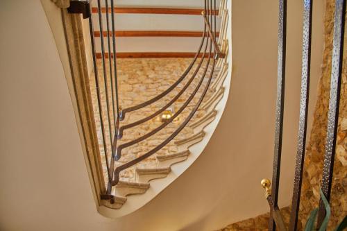 a spiral staircase in a house with a stair railing at Cas Comte Suites & Spa - Adults Only in Lloseta