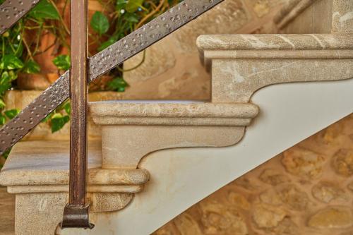 a set of stairs with a metal handrail at Cas Comte Suites & Spa - Adults Only in Lloseta
