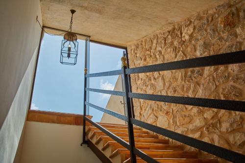 a staircase in a house with a window and a lantern at Cas Comte Suites & Spa - Adults Only in Lloseta