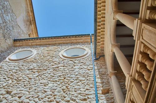 a building with two windows on the side of it at Cas Comte Suites & Spa - Adults Only in Lloseta