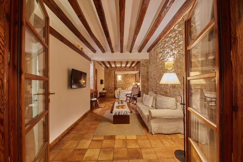 a living room with a couch and a table at Cas Comte Suites & Spa - Adults Only in Lloseta