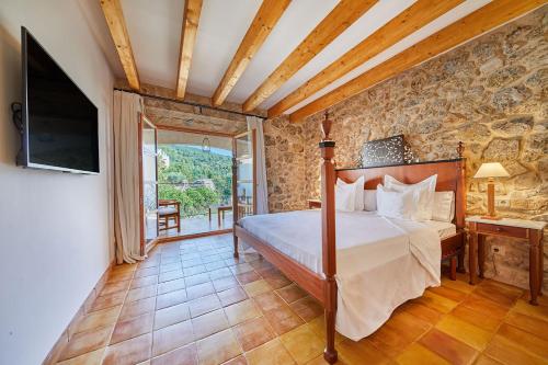 a bedroom with a bed in a room with a tv at Cas Comte Suites & Spa - Adults Only in Lloseta