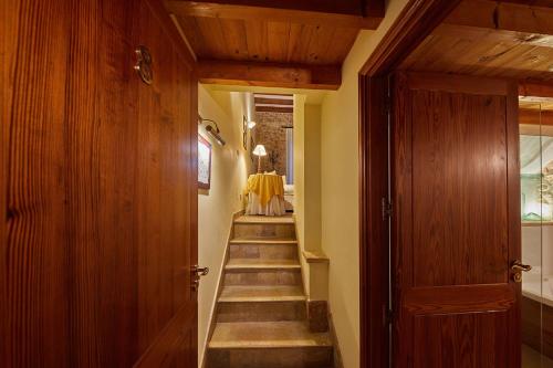 a hallway with a staircase with a yellow dress in the distance at Cas Comte Suites & Spa - Adults Only in Lloseta