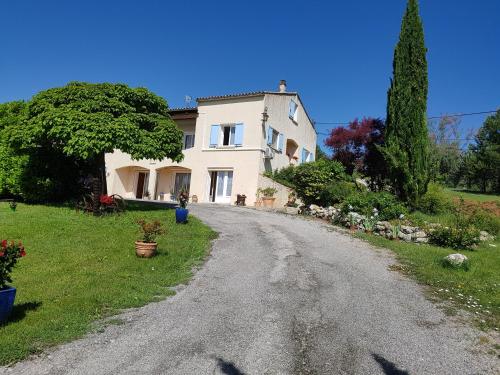 a gravel road leading to a large white house at Propriété St Jean in Lazer