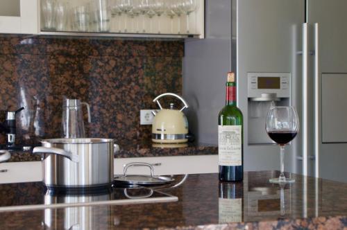 a bottle of wine on a counter with a glass of wine at Haus Meerblau in Born