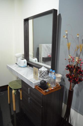 a bathroom with a vanity with a large mirror at Modern room at Sabai Sabai Homestay Ayutthaya in Phra Nakhon Si Ayutthaya