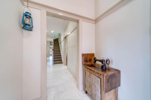 a bathroom with a wooden sink and a hallway at Marulan Stayz in Marulan