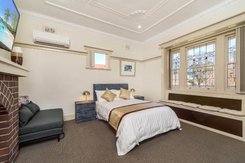 a bedroom with a bed and a chair at Marulan Stayz in Marulan