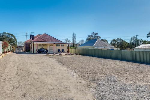 a dirt road in front of a building at Marulan Stayz in Marulan