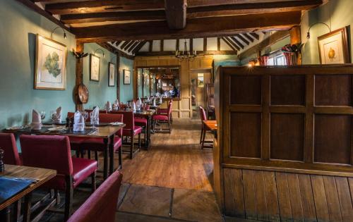 a dining room with tables and chairs in a restaurant at The Bell Inn Hotel in Horndon on the Hill