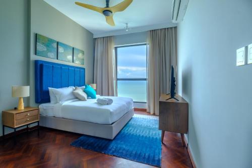 a bedroom with a bed and a window at Tanjung Point Residences in George Town