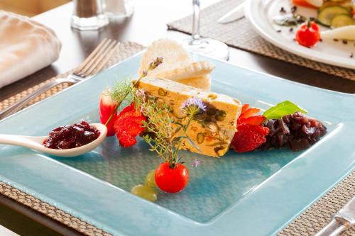 a blue plate with food on a table at Brit Hotel Confort Amiens in Longueau