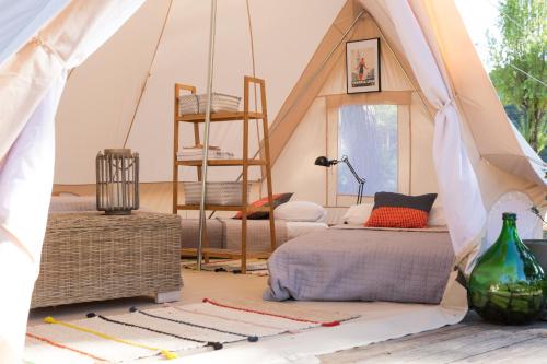 a room with a tent with two beds and a ladder at GoOutside Venezia in Cavallino-Treporti